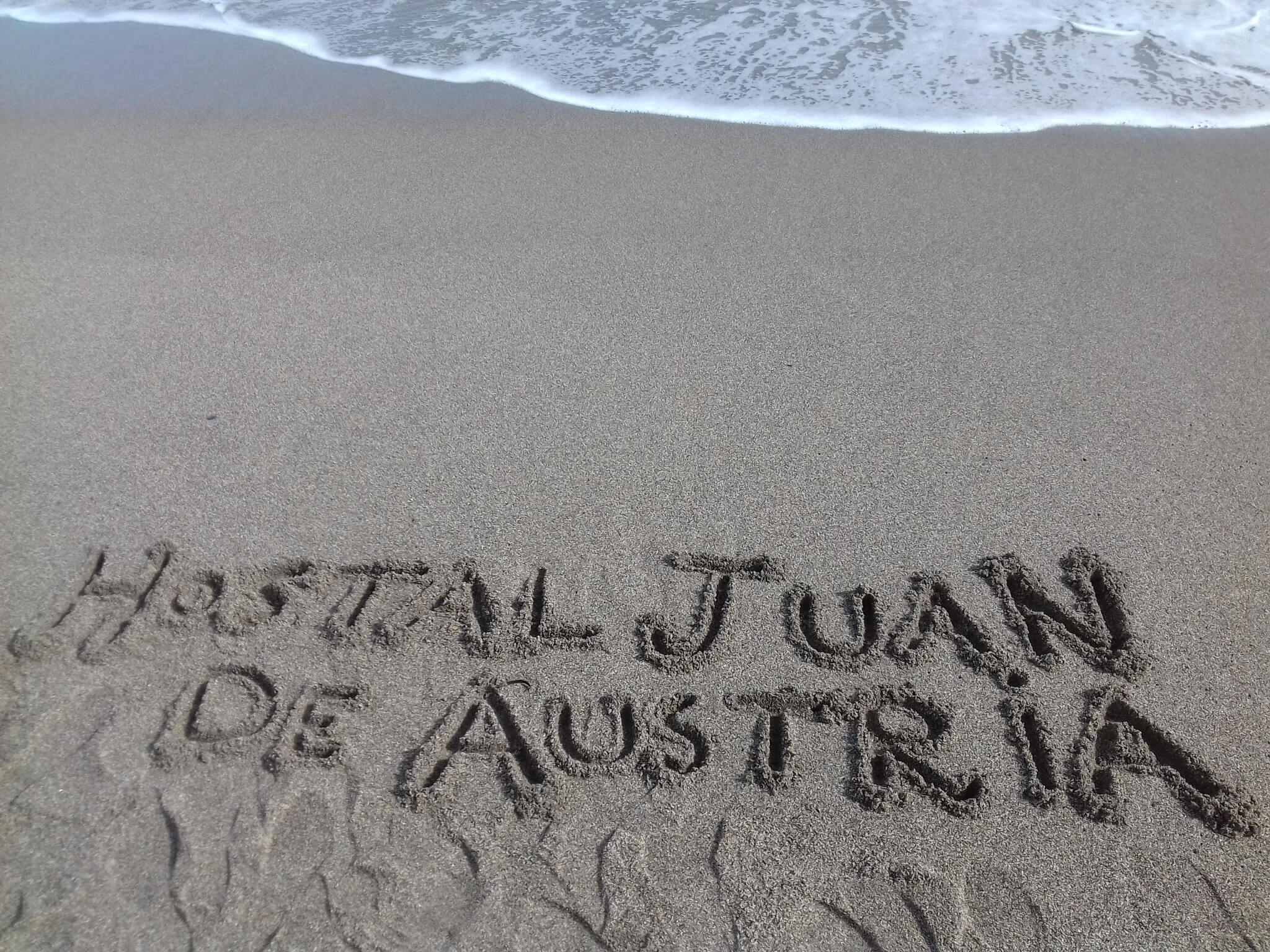 seashore sand written hostel
